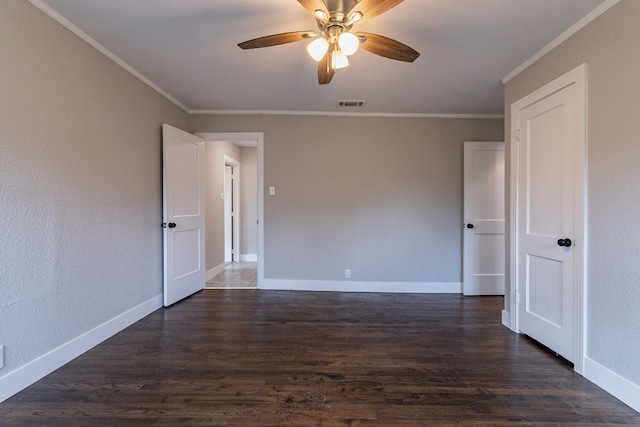 unfurnished room featuring ceiling fan, crown molding, and dark hardwood / wood-style floors