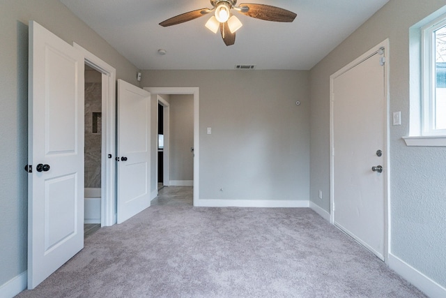 unfurnished bedroom featuring ceiling fan and light carpet