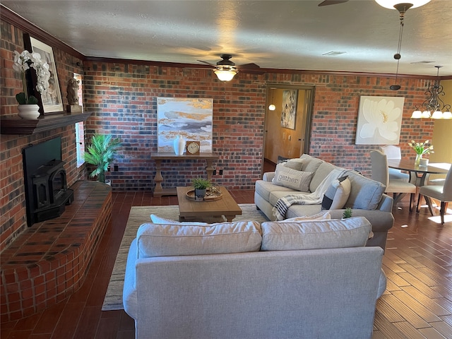 living room with dark hardwood / wood-style flooring, a wood stove, crown molding, and brick wall