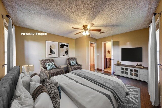 bedroom with dark hardwood / wood-style floors, ceiling fan, and a textured ceiling