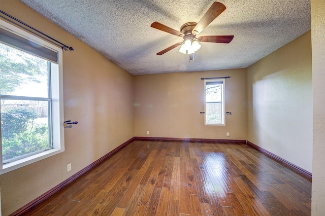 unfurnished room with a textured ceiling, ceiling fan, baseboards, and wood-type flooring