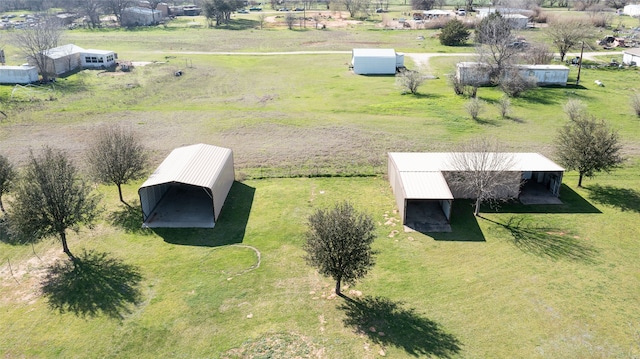 birds eye view of property with a rural view