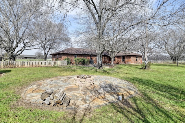 view of yard featuring a fire pit and fence