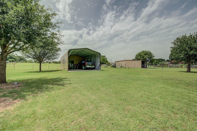 view of yard with a carport and a rural view