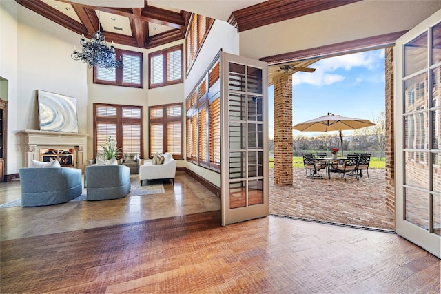 interior space with coffered ceiling, beam ceiling, and ceiling fan