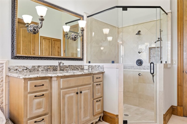 bathroom with a shower with door and vanity