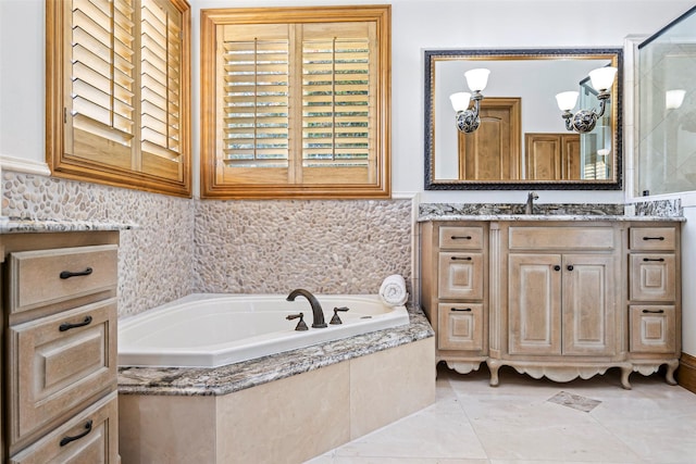 bathroom with vanity and tiled tub