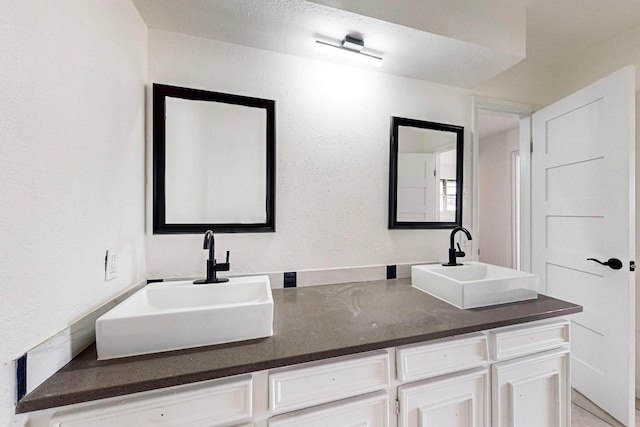 bathroom featuring dual vanity