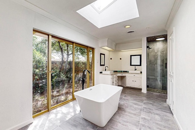 interior space featuring a skylight, plus walk in shower, vanity, ornamental molding, and tile flooring