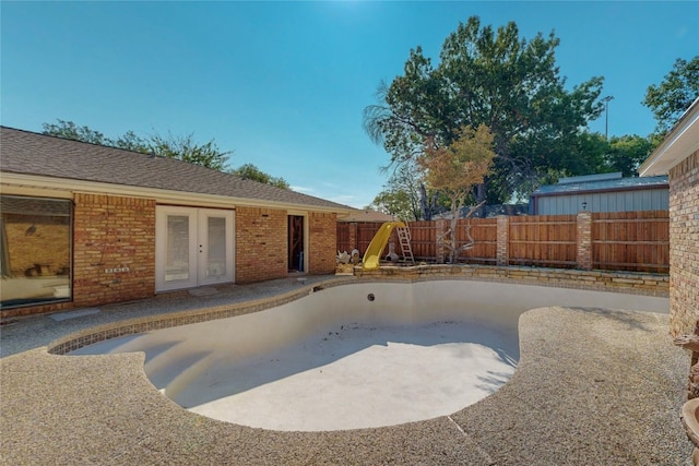 view of swimming pool featuring a patio and french doors