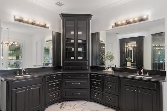 bathroom with vanity, crown molding, and a notable chandelier