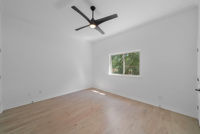 empty room featuring ornamental molding, light wood-type flooring, and ceiling fan