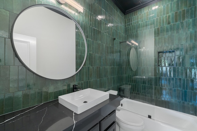 full bathroom featuring vanity, toilet, tile walls, and bathing tub / shower combination