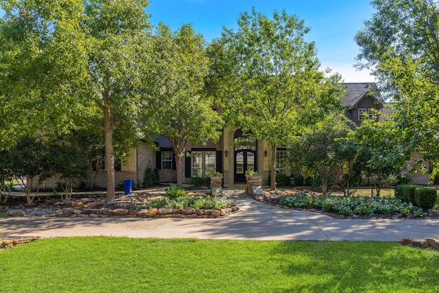 obstructed view of property featuring a front lawn