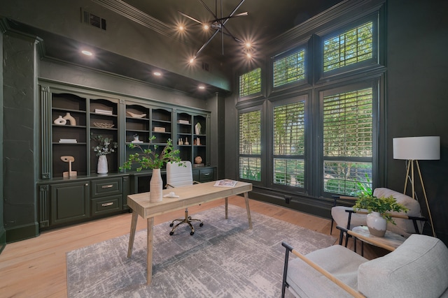 home office with ornamental molding, wood-type flooring, and plenty of natural light