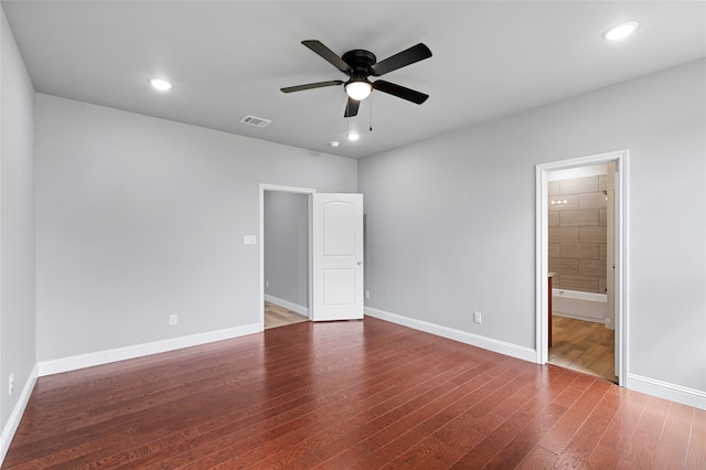 unfurnished bedroom with connected bathroom, ceiling fan, and wood-type flooring