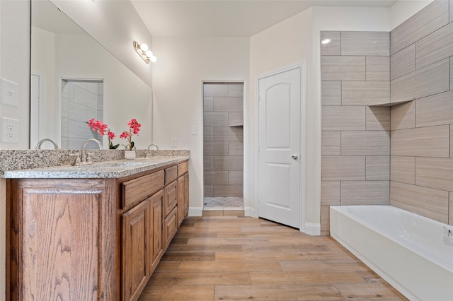 bathroom with vanity, wood-type flooring, and separate shower and tub