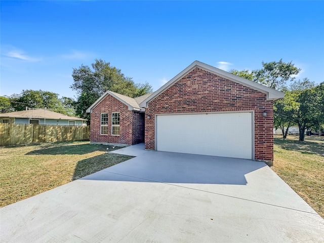 view of front of home featuring a front yard and a garage