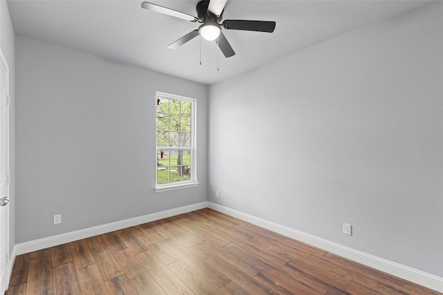 spare room featuring wood-type flooring and ceiling fan