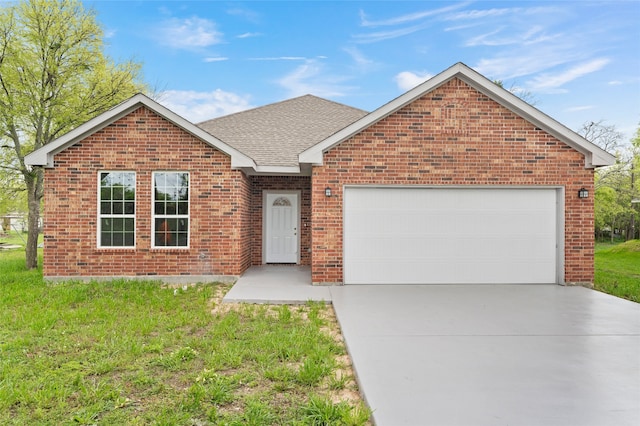 view of front facade with a front yard and a garage