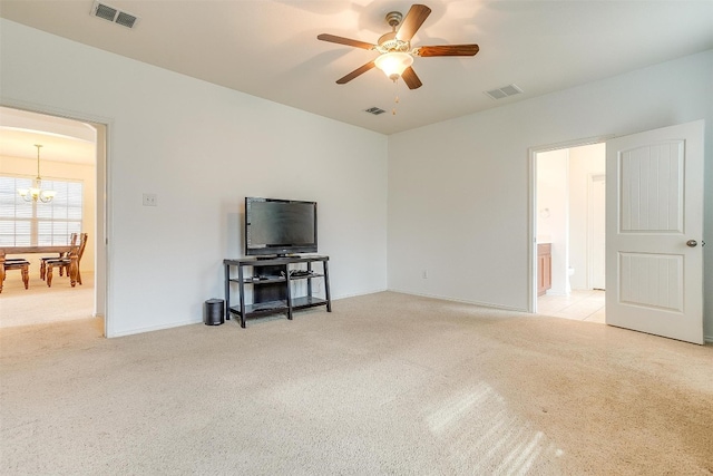 interior space featuring light carpet and ceiling fan with notable chandelier