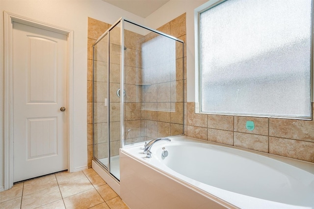 bathroom featuring separate shower and tub and tile flooring