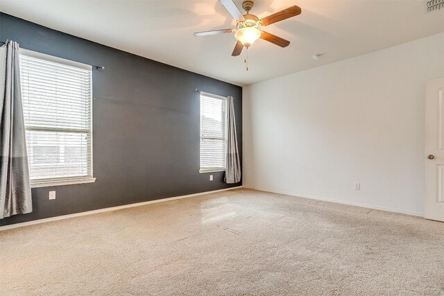 empty room with light colored carpet and ceiling fan