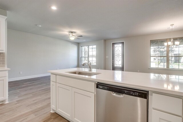 kitchen with dishwasher, sink, white cabinets, and kitchen peninsula