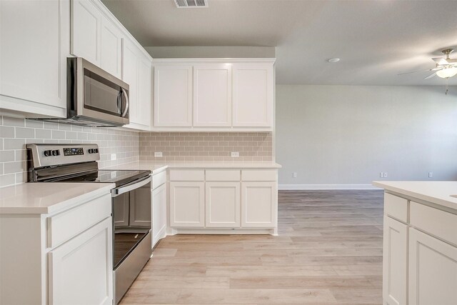 kitchen with white cabinetry, sink, stainless steel dishwasher, and hanging light fixtures