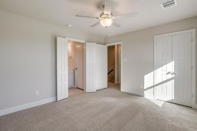 carpeted spare room featuring ceiling fan