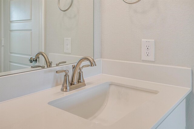 bathroom featuring a shower with door, vanity, and tile patterned floors