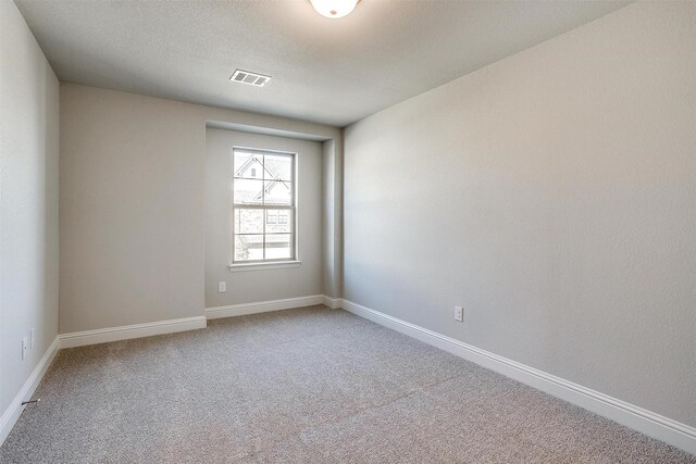 unfurnished room with light carpet