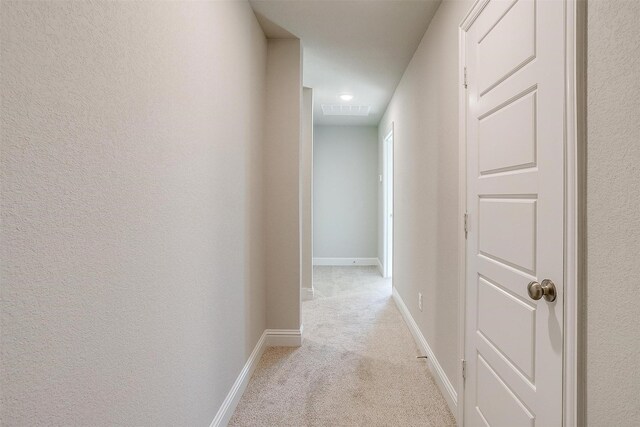 unfurnished bedroom with light colored carpet and a closet