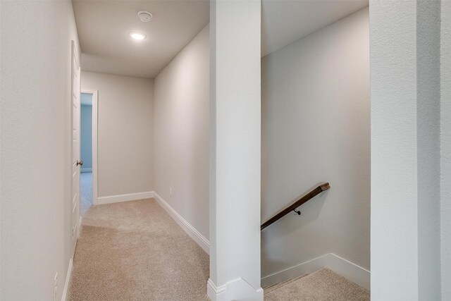 hallway with light colored carpet