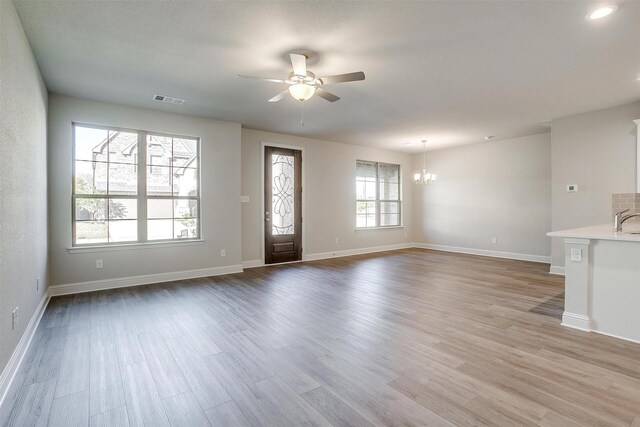 unfurnished room with ceiling fan and light wood-type flooring