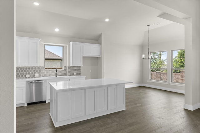 kitchen featuring stainless steel dishwasher, a center island, and white cabinets