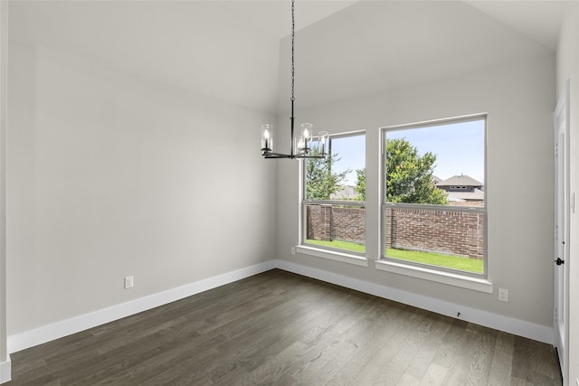 unfurnished dining area featuring dark wood-type flooring, vaulted ceiling, and an inviting chandelier