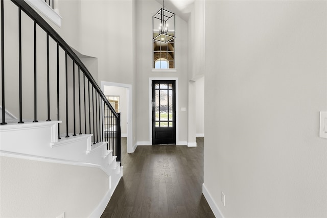 foyer with a chandelier, a high ceiling, and dark hardwood / wood-style flooring