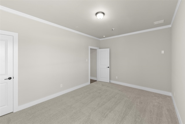 unfurnished room with light colored carpet and crown molding