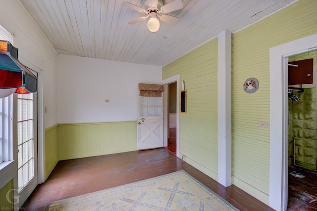 unfurnished room featuring dark hardwood / wood-style flooring, ceiling fan, and a wealth of natural light