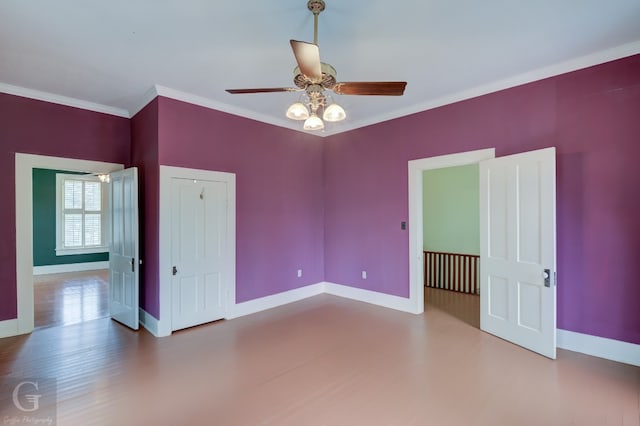 empty room with dark hardwood / wood-style floors, ceiling fan, and ornamental molding