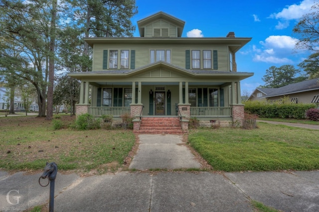 view of front facade featuring a front lawn and covered porch