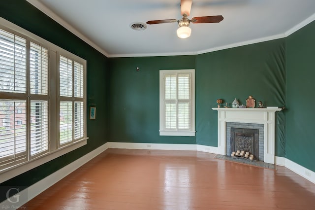 unfurnished living room featuring ceiling fan, crown molding, hardwood / wood-style flooring, and plenty of natural light