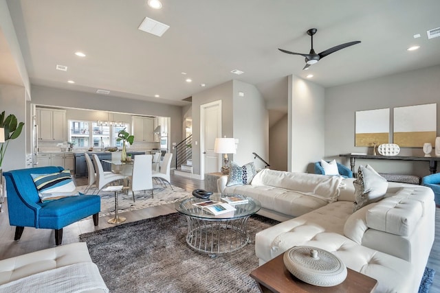 living room featuring light hardwood / wood-style floors and ceiling fan