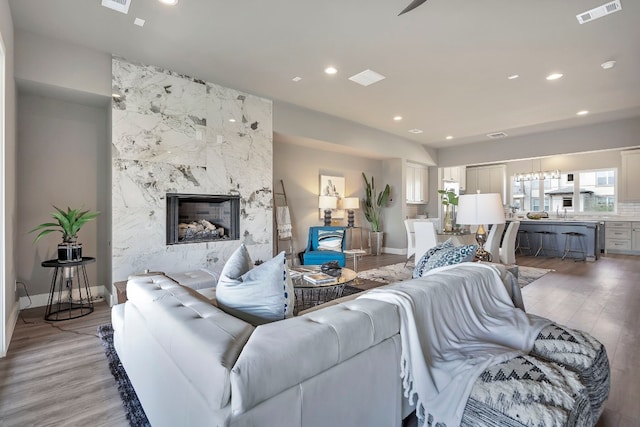 living room with light wood-type flooring and a premium fireplace