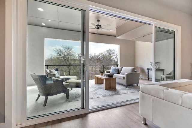 doorway to outside featuring light hardwood / wood-style floors, ceiling fan, and a wealth of natural light