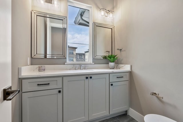 bathroom featuring vanity, tile flooring, and toilet