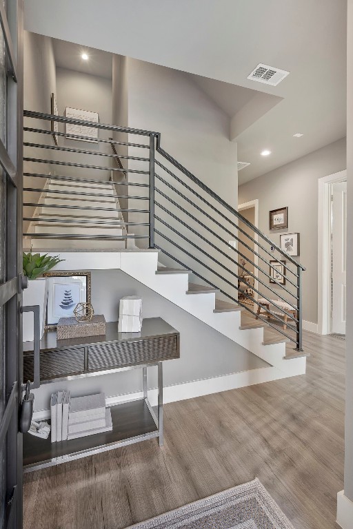 stairs featuring wood-type flooring