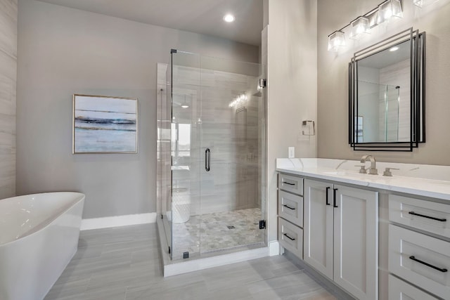 bathroom with shower with separate bathtub, tile floors, and vanity