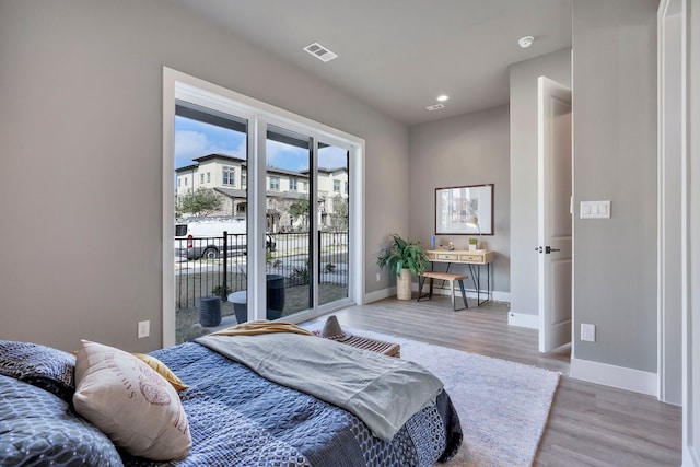 bedroom featuring light wood-type flooring and access to exterior